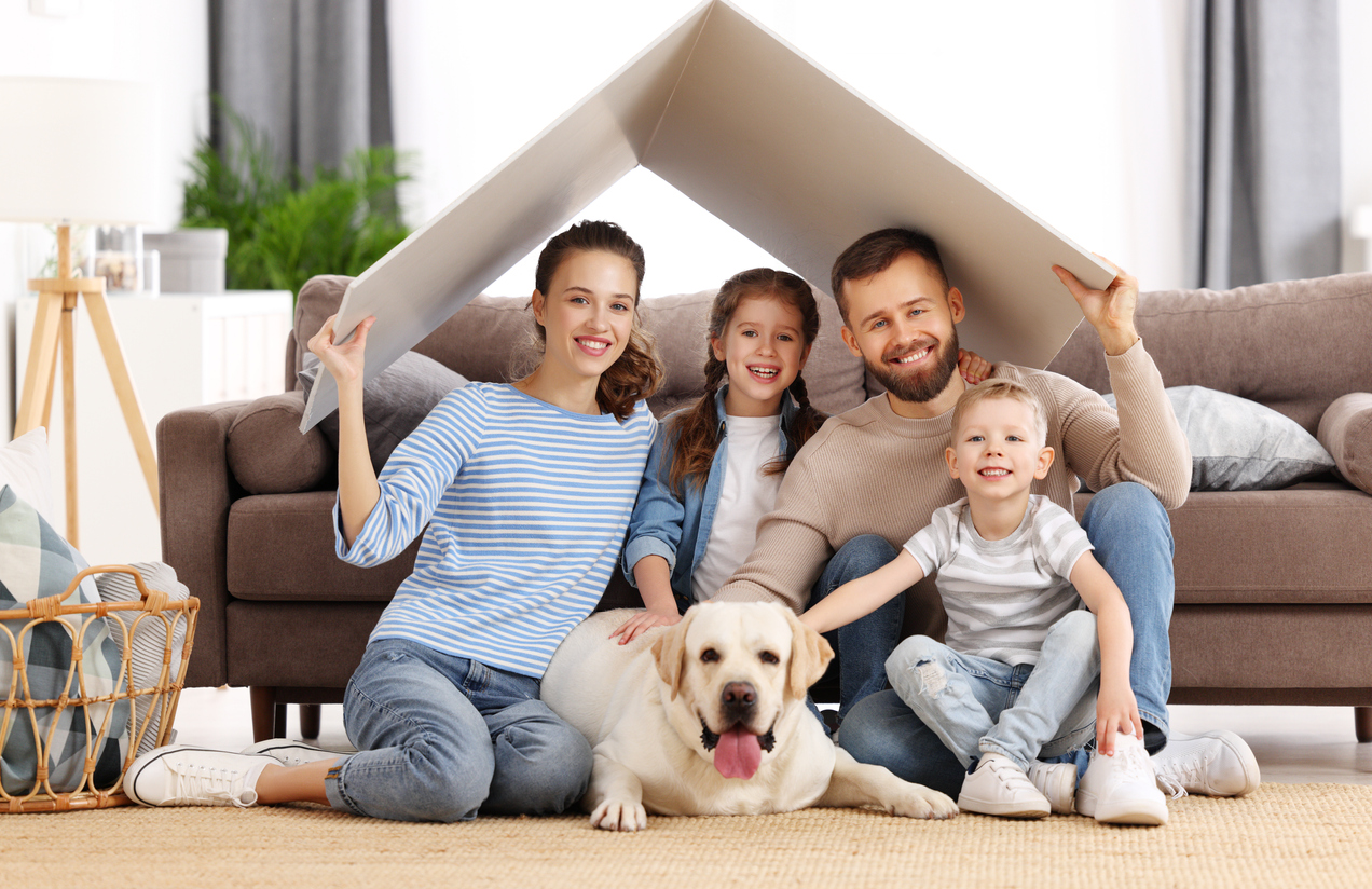 Happy family with dog enjoying new home